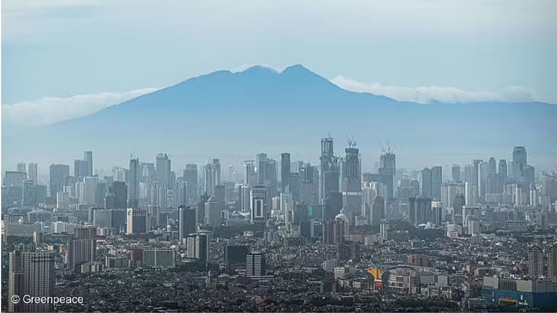 Gunung Salak menjadi latar belakang Jakarta. (Greenpeace)